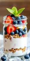 Healthy yogurt parfait with fresh fruits and granola in a jar ready to be enjoyed for breakfast or dessert photo