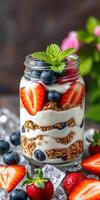 Delicious berry granola parfait served in a jar with fresh strawberries and blueberries in a bright kitchen setting photo