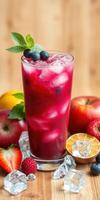 Refreshing summer berry drink with mint served in a tall glass surrounded by fresh fruits and ice cubes photo