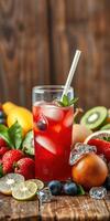 Refreshing fruit cocktail with colorful ingredients and ice served in a clear glass on a wooden table photo