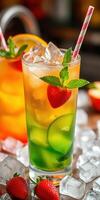 Refreshing colorful cocktail served in a tall glass with ice, fruit, and mint leaves at a summer gathering photo