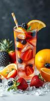 Refreshing fruit cocktail featuring strawberries, blueberries, and citrus served in a tall glass with ice photo