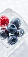 Refreshing frozen berries in ice for a cool beverage on a sunny day photo