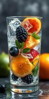 Fresh fruit cocktail served in a tall glass with ice and mint at a vibrant setting photo