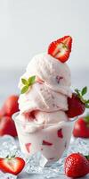 Delicious homemade strawberry ice cream served in a clear cup with fresh strawberries and mint photo