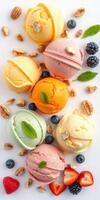 Colorful assortment of ice cream scoops with fresh fruits and nuts arranged on a white background photo