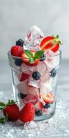 Refreshing summer fruit beverage with ice and mint on a light background photo