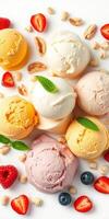 Colorful assortment of scoops of ice cream surrounded by fresh fruit and nuts on a bright background photo
