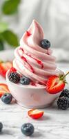 Soft serve ice cream topped with fresh strawberries, blueberries, and blackberries in a bowl photo
