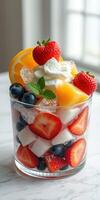 Refreshing summer fruit dessert with strawberries, blueberries, and melon topped with whipped cream photo