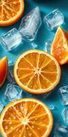 Slices of fresh orange with ice cubes on a vibrant blue background photo