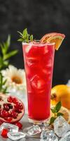 Refreshing pomegranate lemonade served in a tall glass with mint garnish and citrus slices on a table photo