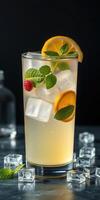 Refreshing cocktail featuring raspberries, lemon, and mint served over ice at a bar setting in the evening photo