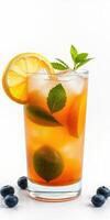 Refreshing citrus beverage garnished with mint and blueberries served in a tall glass photo