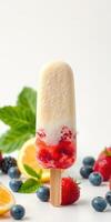 Homemade fruit popsicle with layers of strawberry, lemon, and blueberry on a white background photo