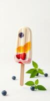 Colorful fruit popsicle with mint and berries on a white background photo