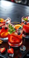 Colorful fruit cocktails with vibrant garnishes served on a black surface during a summer gathering photo