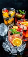 Refreshing fruit cocktails served in glasses with ice and garnished with mint leaves photo