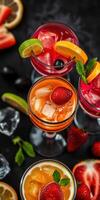 Colorful cocktails garnished with fresh fruits and mint arranged on a dark surface during a summer gathering photo
