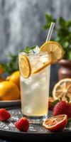Refreshing lemonade with fresh strawberies and lemon slices on a summer day photo