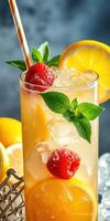 Refreshing raspberry lemonade served in a tall glass with mint leaves and lemon slices photo