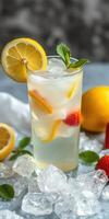 Refreshing citrus drink with lemon, mint, and strawberries served over ice on a cool background photo