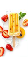 Colorful fruit popsicle with strawberries, mango, and mint on ice photo