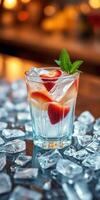 Refreshing drink with strawberries and mint garnished over ice on bar counter in cozy setting photo