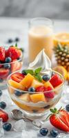 Fresh fruit salad with berries and creamy topping in a sunny kitchen setting photo
