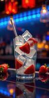 Refreshing fruit cocktail with ice cubes and strawberries at a vibrant bar during the evening photo