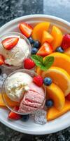 Colorful fruit and ice cream dessert served on a white plate with fresh berries and mint garnish photo