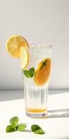 Refreshing citrus drink with lemon and mint served in a clear glass under natural light photo