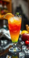 Colorful layered cocktail garnished with orange and mint served on a bar counter photo