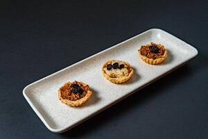 a tray of muffins with one that has the word cranberries on it. photo