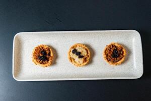 a tray of muffins with one that has the word cranberries on it. photo
