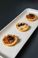 a tray of muffins with one that has the word cranberries on it. photo
