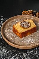 a piece of cake with a slice of lemon on it photo