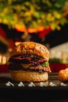 a burger with a bun and a christmas tree in the background. photo