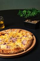 a pizza with onions and onions on it sits on a table. photo