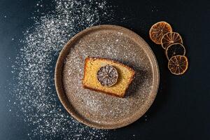 a piece of cake with a slice of lemon on it photo