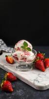 Delicious strawberry ripple ice cream served in a clear bowl with fresh strawberries on a marble surface photo