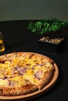 a pizza with onions and onions on it sits on a table. photo