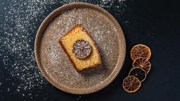a piece of cake with a slice of lemon on it photo