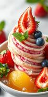 Delicious dessert featuring layered creamy treat topped with fresh strawberries and blueberries in a bowl photo
