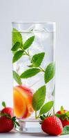 Refreshing drink with fruits and herbs garnished in a clear glass, perfect for hot summer days photo