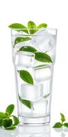 Refreshing mint and ice beverage served in a tall glass with clear bubbles on a bright background photo