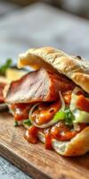 Savory sandwich with tender meat and flavorful sauce on rustic wooden board photo