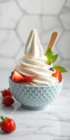 Creamy frozen yogurt topped with fresh fruits and mint in a decorative bowl photo