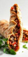 Savory meat wrap filled with vegetables and spices on a bright background photo