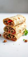 Delicious rolled tortillas filled with seasoned beef and fresh vegetables stacked artfully on a clean surface photo